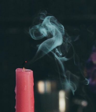 Pink candle blown out, with smoke lingering in the air